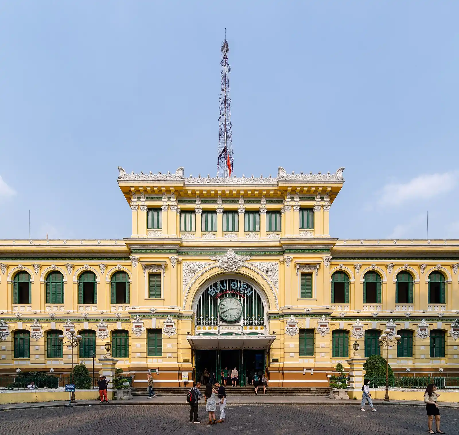 Yellow colonial-era façade of the Saigon Central Post Office under a blue sky