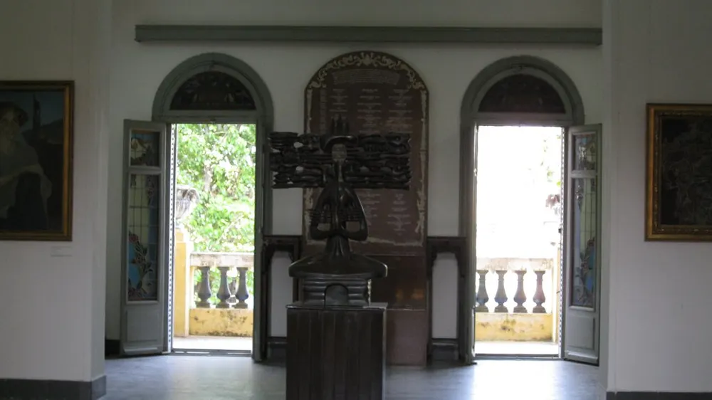Tall doorways and a dark wooden interior at the Ho Chi Minh City Museum of Fine Arts