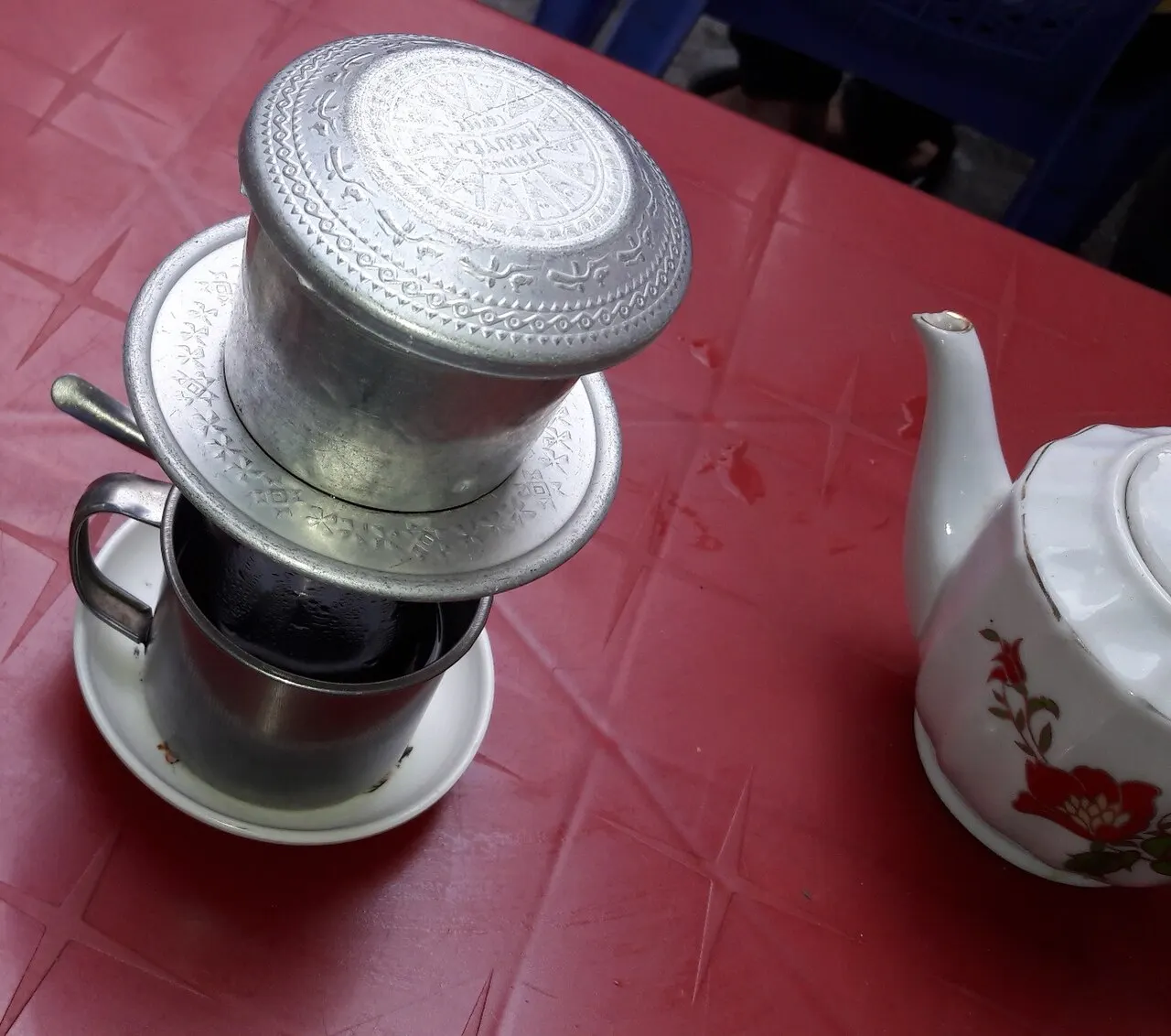 Vietnamese phin coffee on a pavement café table in District 3, Ho Chi Minh City