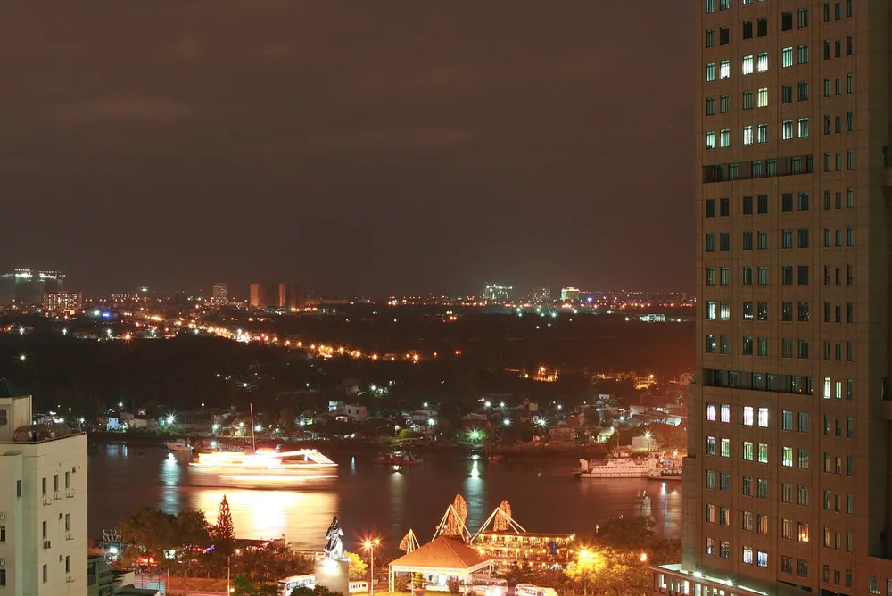 Saigon River and the city lit up at night, seen from a high building