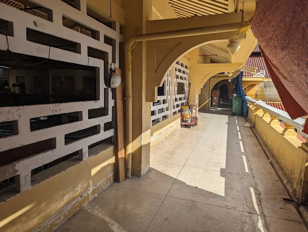 Arched yellow corridor inside Bình Tây Market