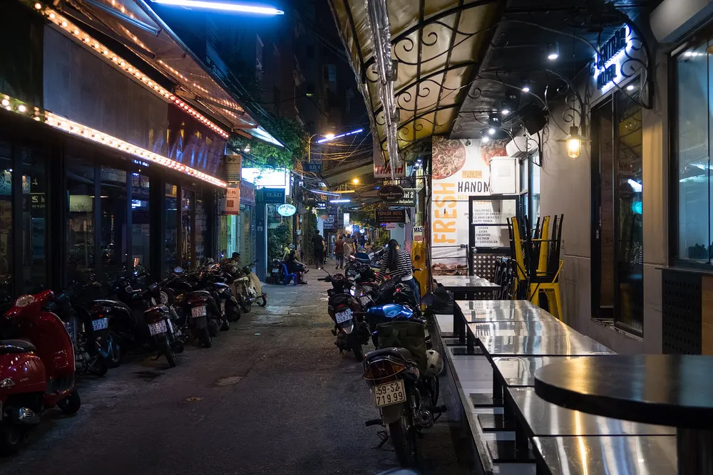 Narrow lit alley at night in central Saigon