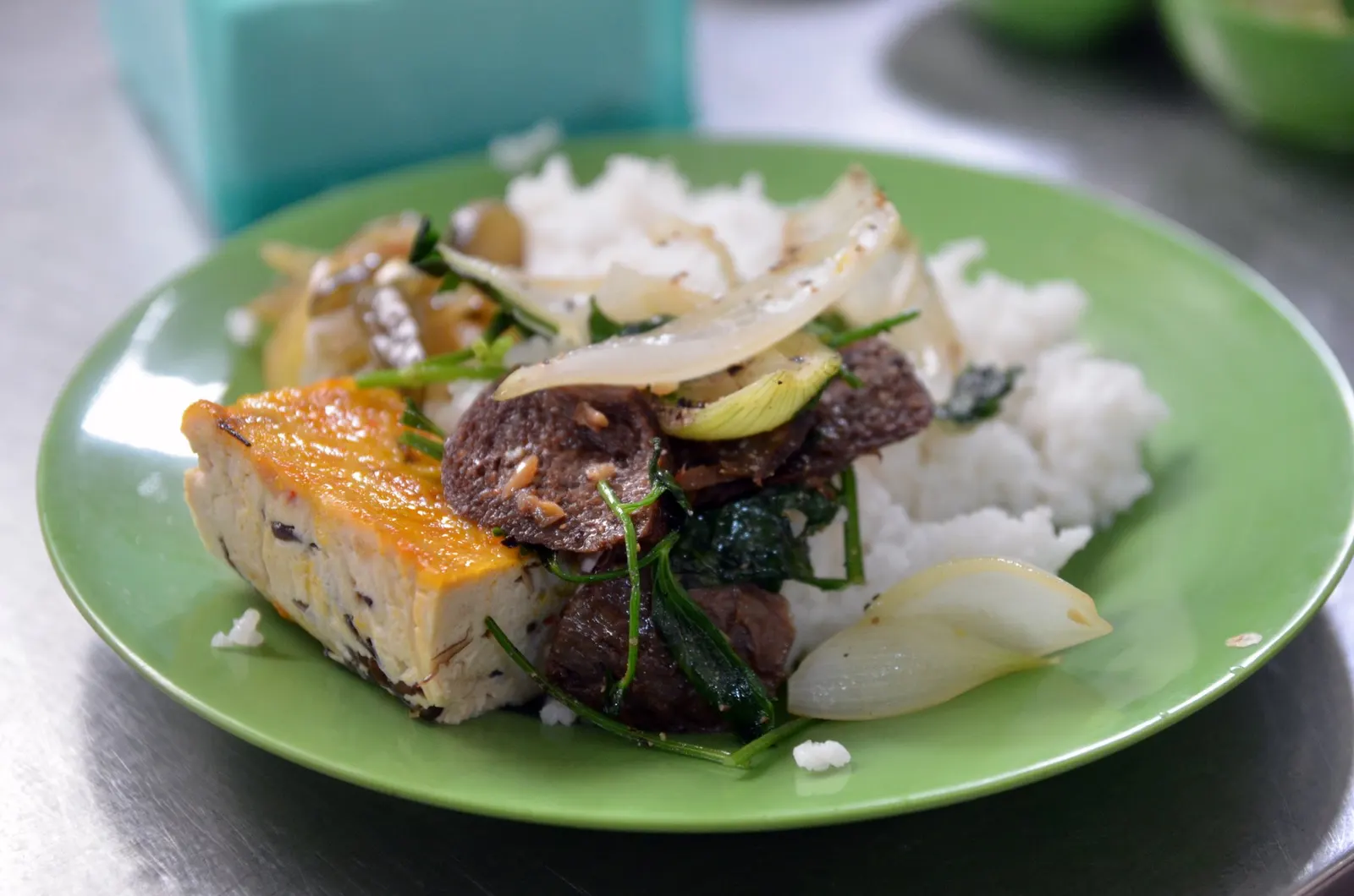 Plate of rice with tofu, mushrooms and vegetables at a small Buddhist vegetarian restaurant in Ho Chi Minh City