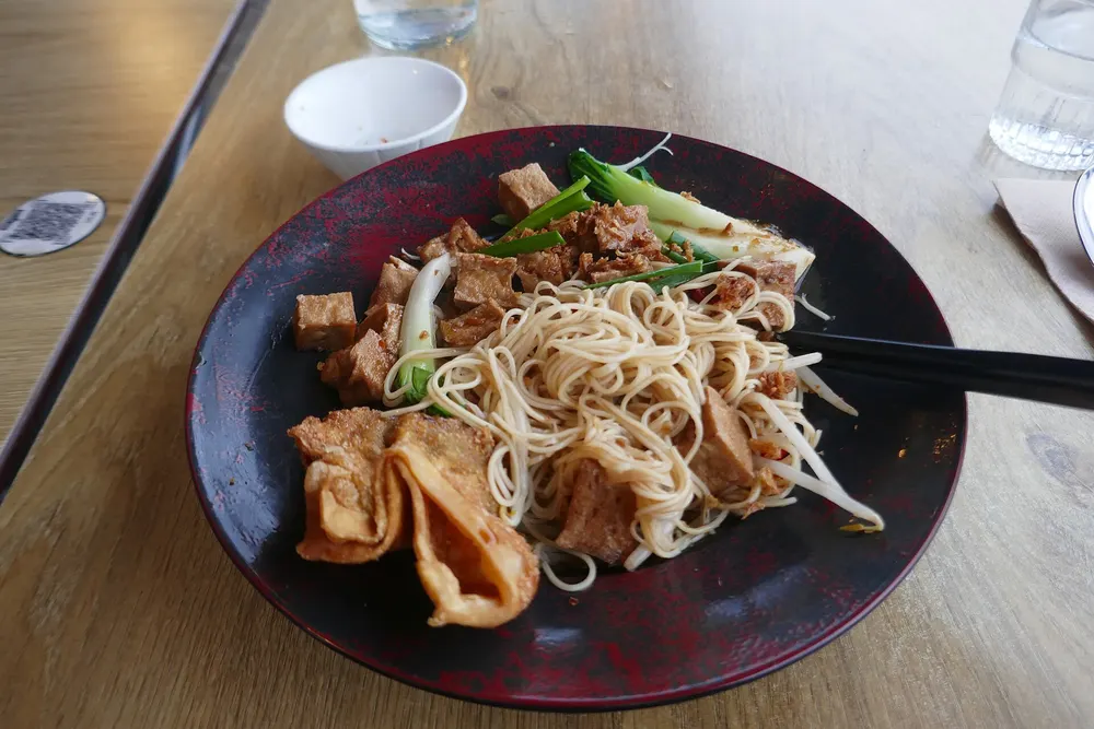 Plate of stir-fried noodles with tofu and vegetables