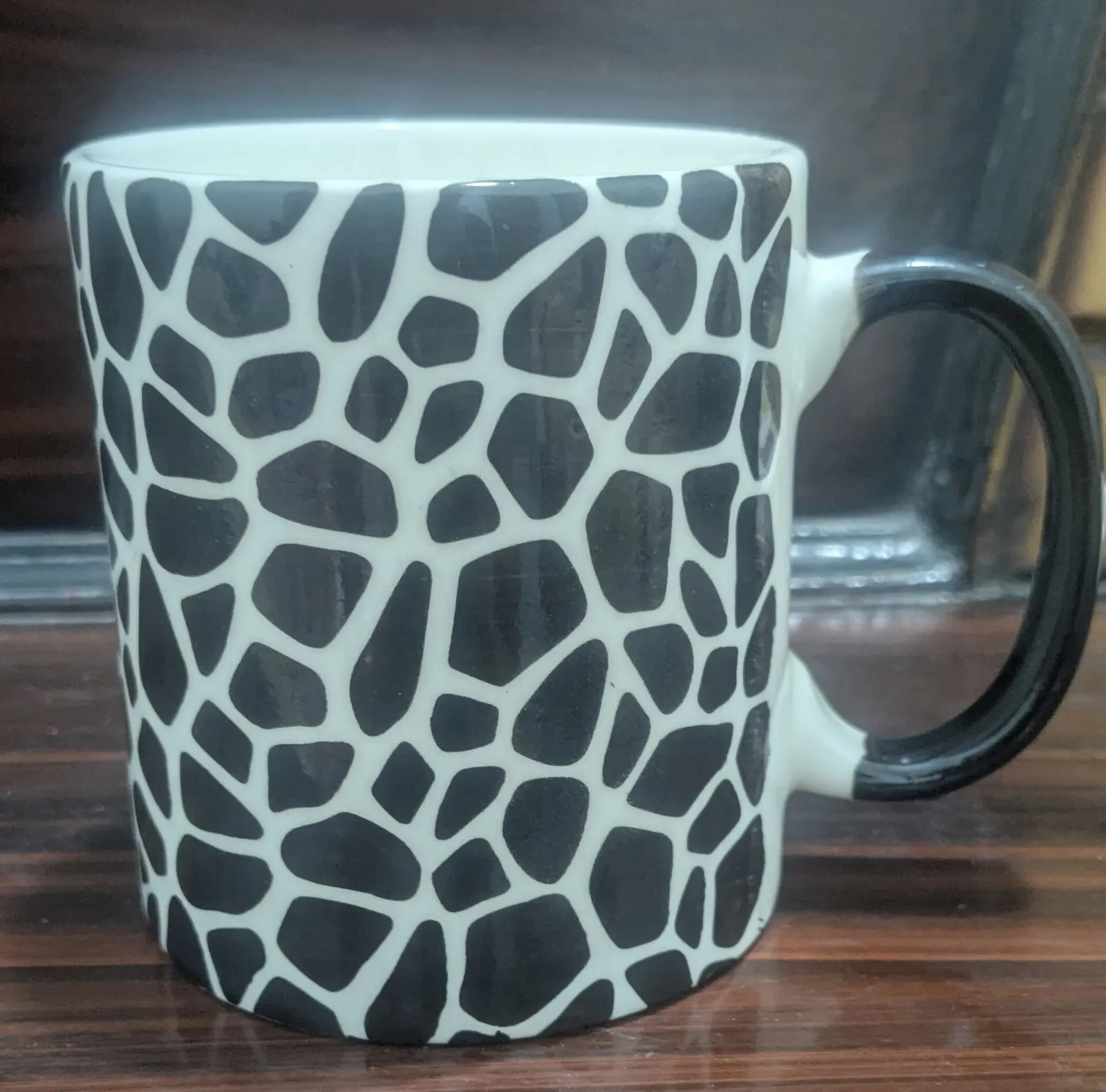 Ceramic mug with a black-and-white pattern