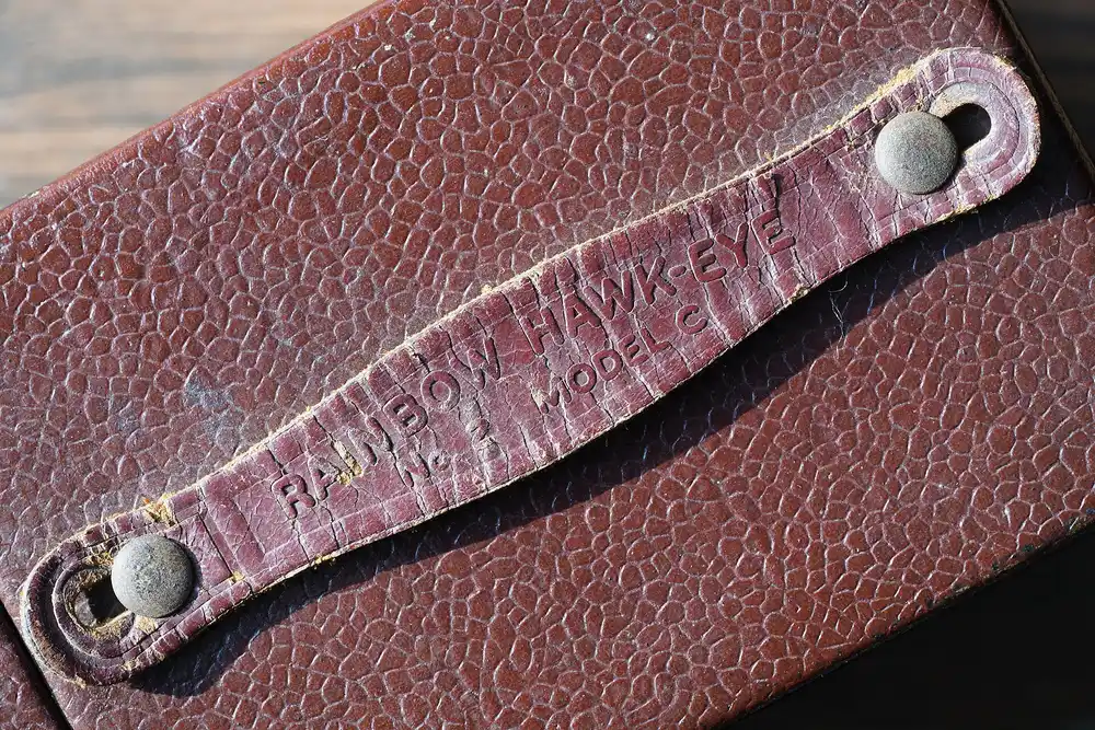 Close-up of a worn leather camera strap