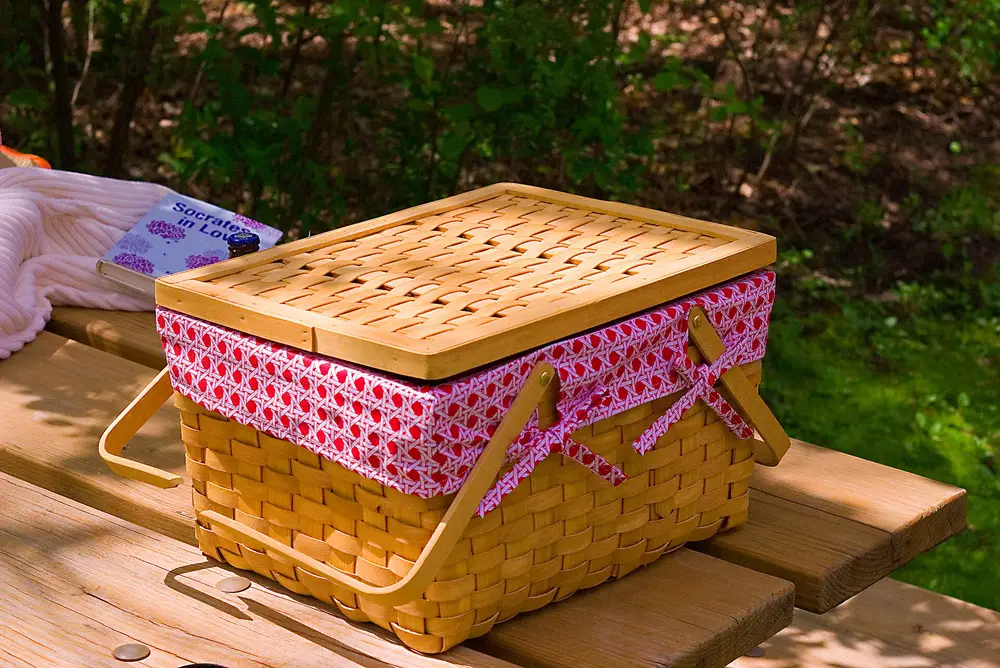 Pink and wicker picnic basket on a table