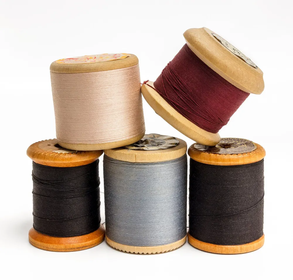 Wooden spools of sewing thread in several colours